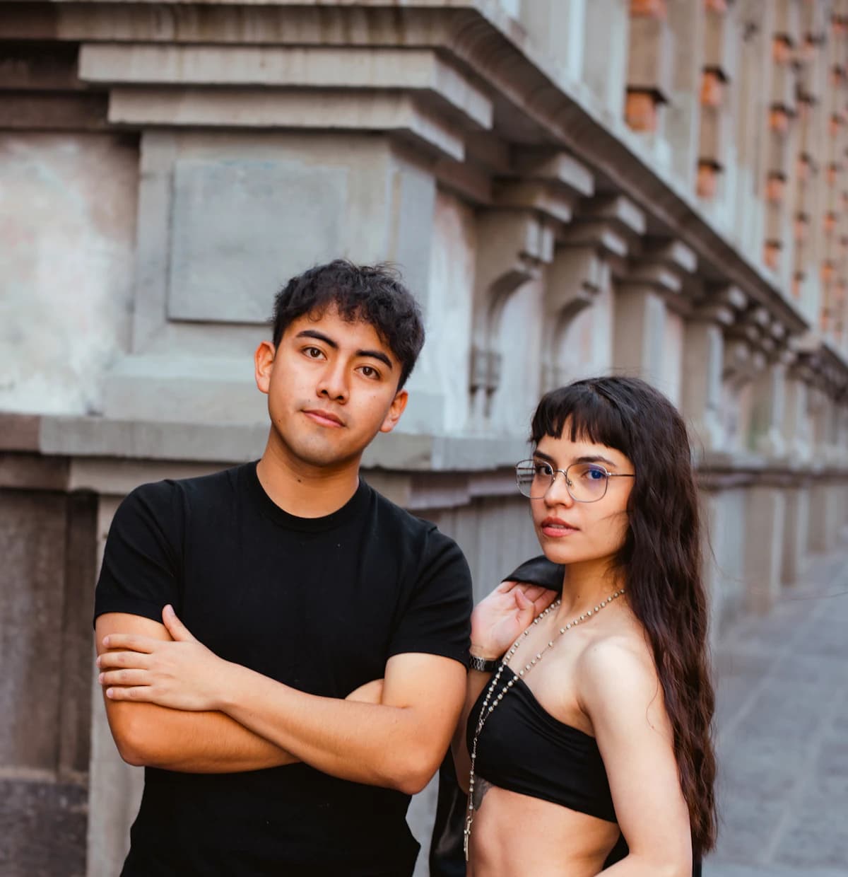 Two young people standing together in the city